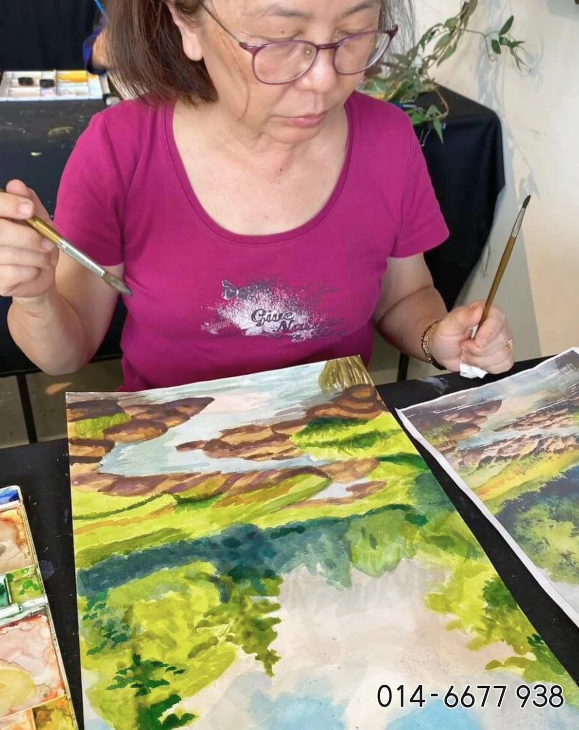 Adult student painting a landscape during Rycca watercolor class