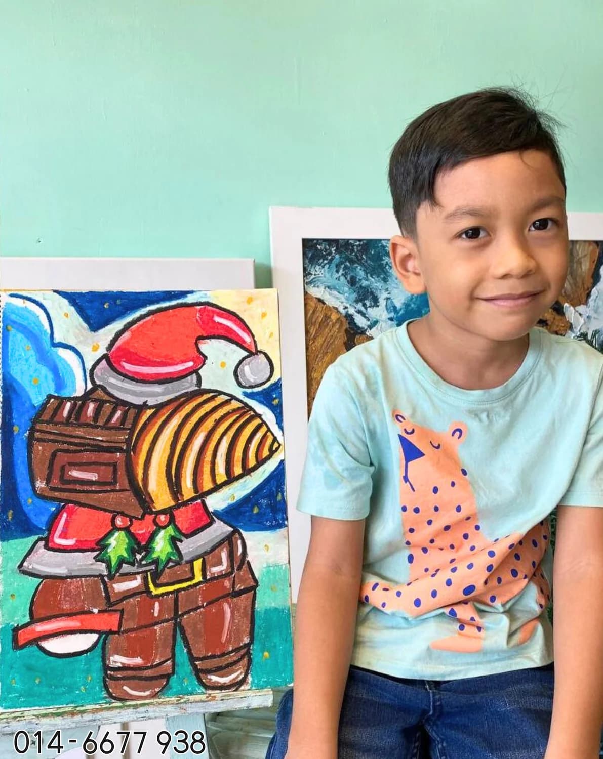 Boy holding astronaut and planet painting from Rycca kids art class