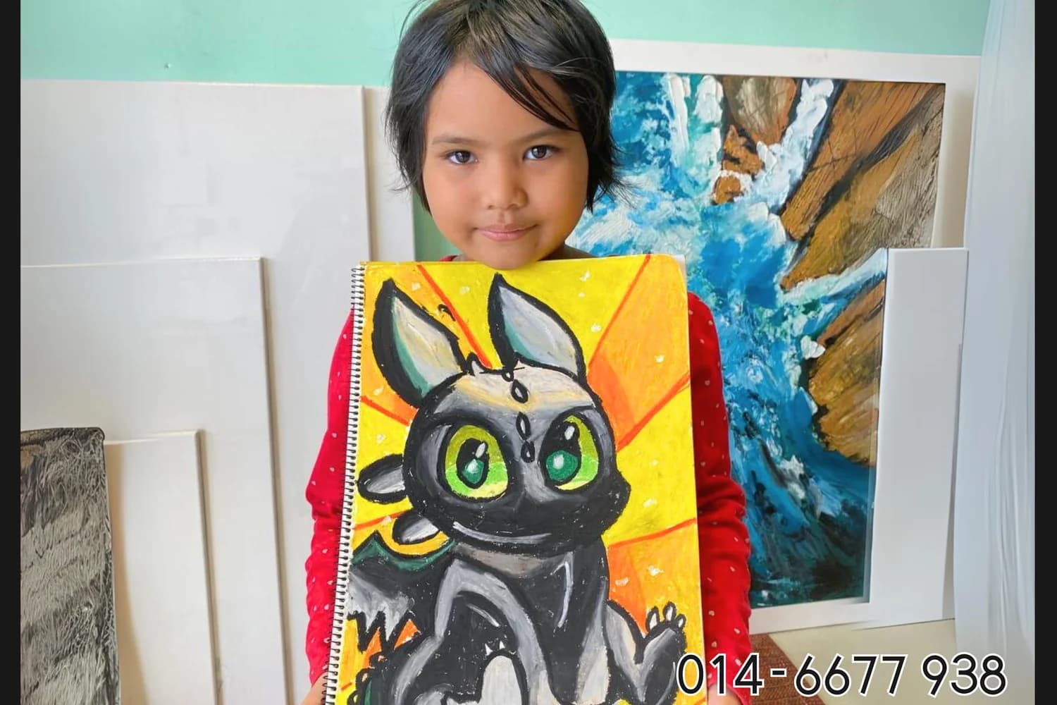 Girl holding black cat cartoon painting from Rycca kids art class