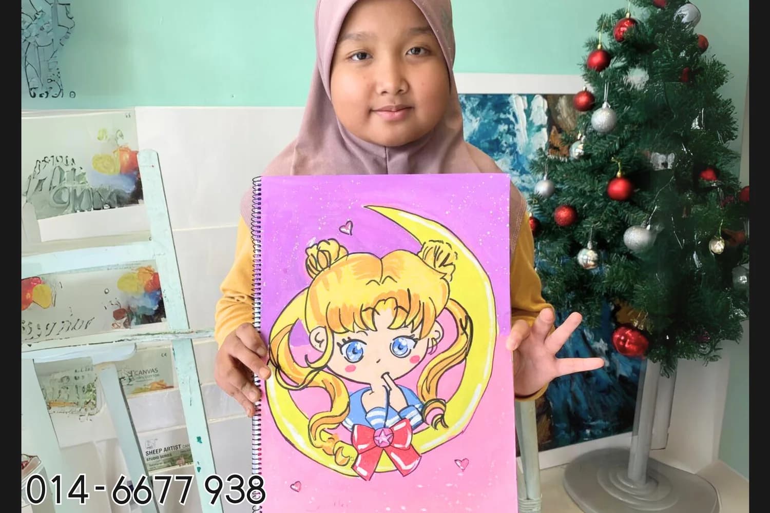 Girl holding pink anime character artwork from Rycca creative art class